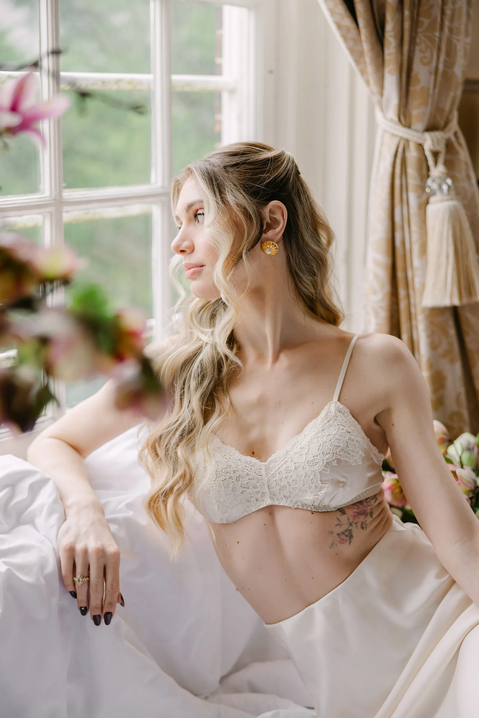 Soft romantic beauty look in window light, with a translucent base, flushed cheek and a sheer lip.